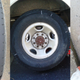 Left and right: front tires. Center: one of the rear wheels. Those four silver lines on the sidewall? Yeah, those are pointing to repair plug locations in the tread.